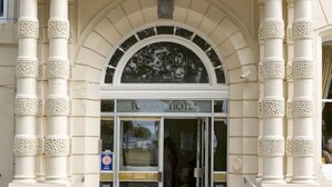 The Torbay Hotel entrance with a classic arched doorway, columns, and a sign above the entrance. - The Caledonian Torbay Hotel (Torquay)
