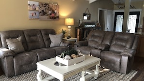 A living room with a sectional sofa, a white coffee table, and a rug. - On the Golf Course Home w amazing views!  (San Jose)