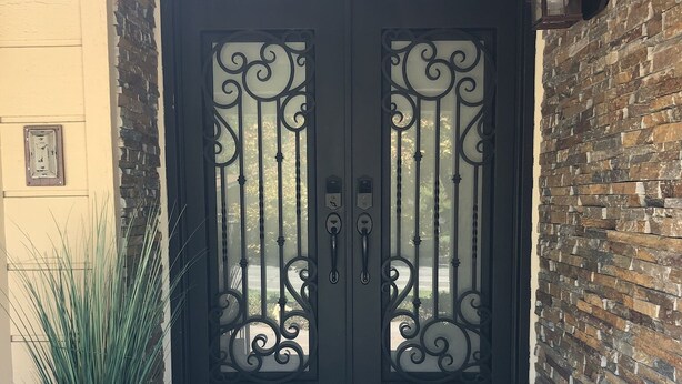 A black double door with decorative ironwork, a potted plant to the left, and a doormat with a large 'N' in front. - On the Golf Course Home w amazing views!  (San Jose)