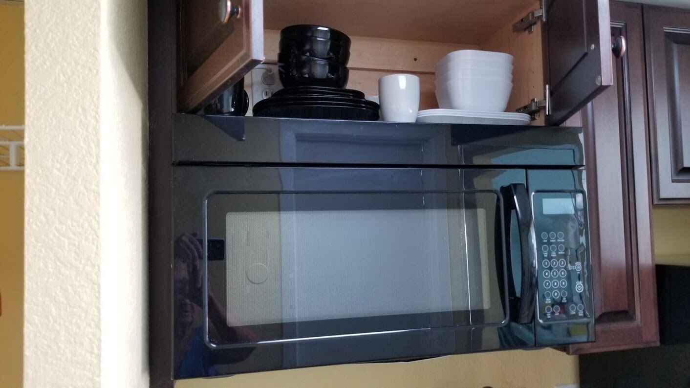 A kitchen with a microwave and a coffee maker.