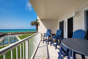 Enjoy the ocean view from this balcony with comfortable seating for four.