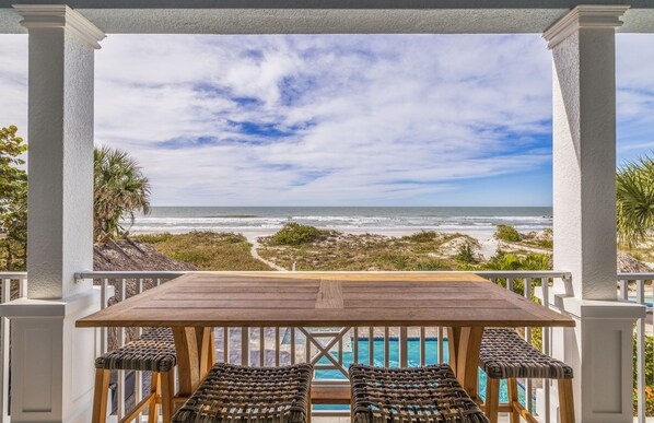 Outdoor dining - Beach Trail House – Gulf-Front Luxury w/ Heated Pool, Game Room, Sunset Balconies & Beach Access (Indian Rocks Beach)