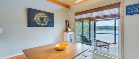Enjoy a meal at the dining table with a view of the lake from the large window.