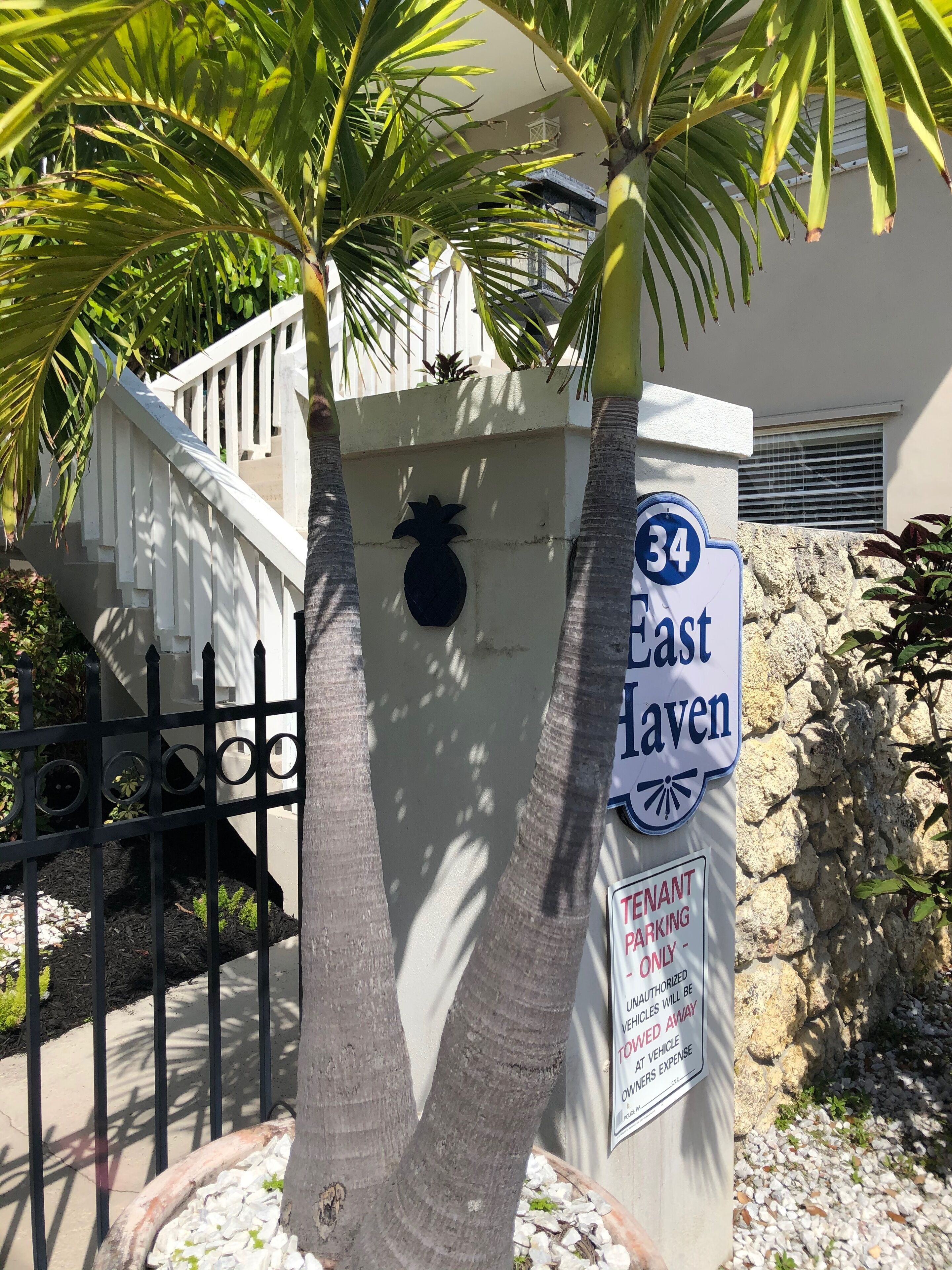 A street sign for '34 East Haven' with a 'Tenant Parking Only' sign below it.