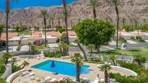 A resort with a swimming pool, palm trees, and a mountainous backdrop. - Golf Course Retreat w/ Private Casita Steps to La Quinta Resort & Pools (La Quinta)