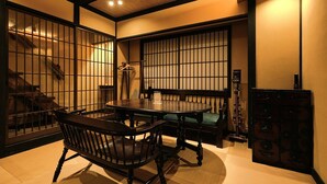 A traditional Japanese-style room with tatami flooring, a low table, and shoji screens.