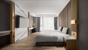 A modern bedroom with a large bed, a TV mounted on the wall, a desk, and a window with curtains. - Gamalan FL Spring Hotel (Jiaoxi)