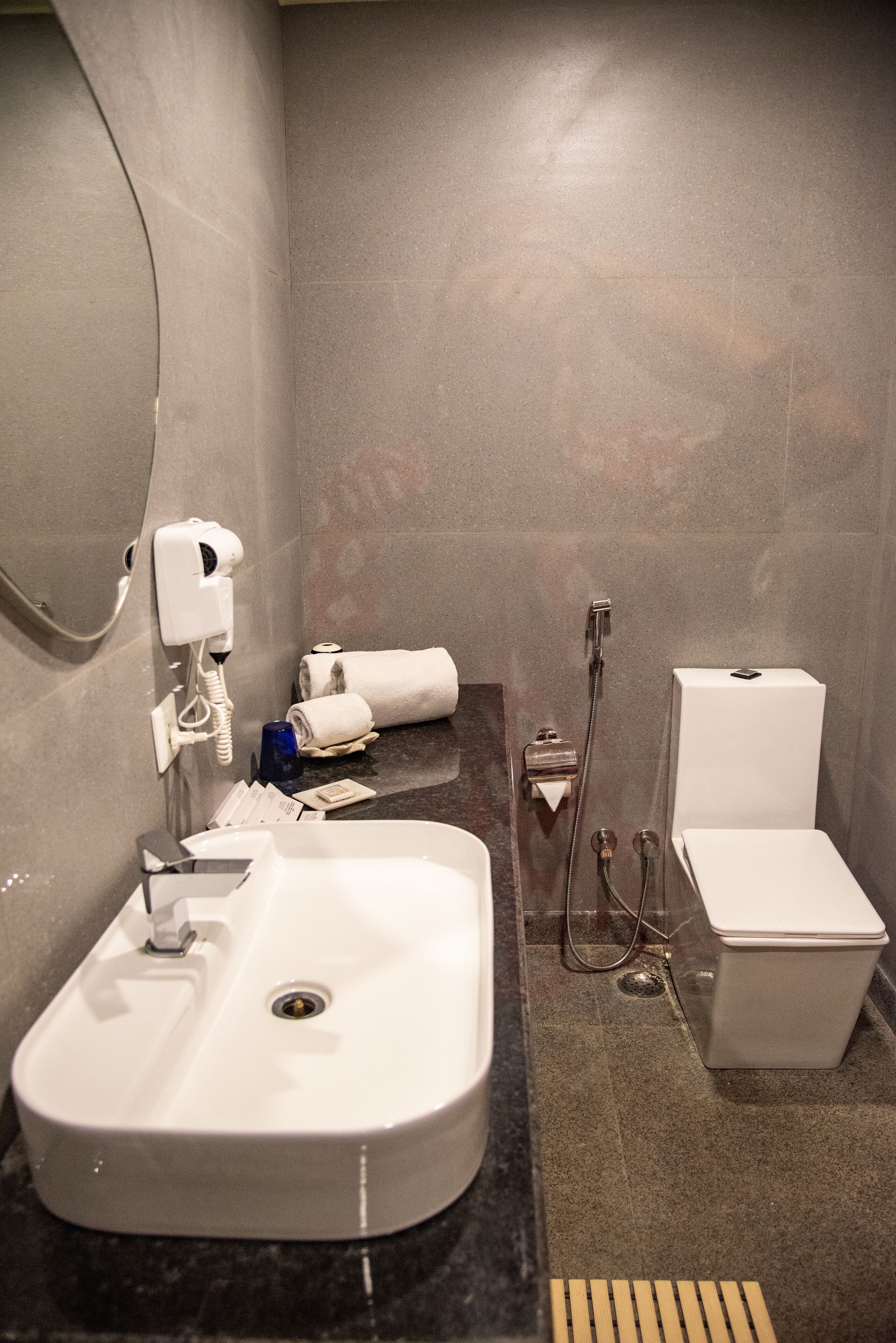 A modern bathroom with a sink, toilet, and shower.