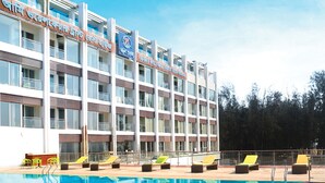 Un hôtel doté d’une piscine, de plusieurs balcons et d’une enseigne indiquant qu’il s’agit d’un établissement de repos géré par un organisme de bien-être pour les militaires.