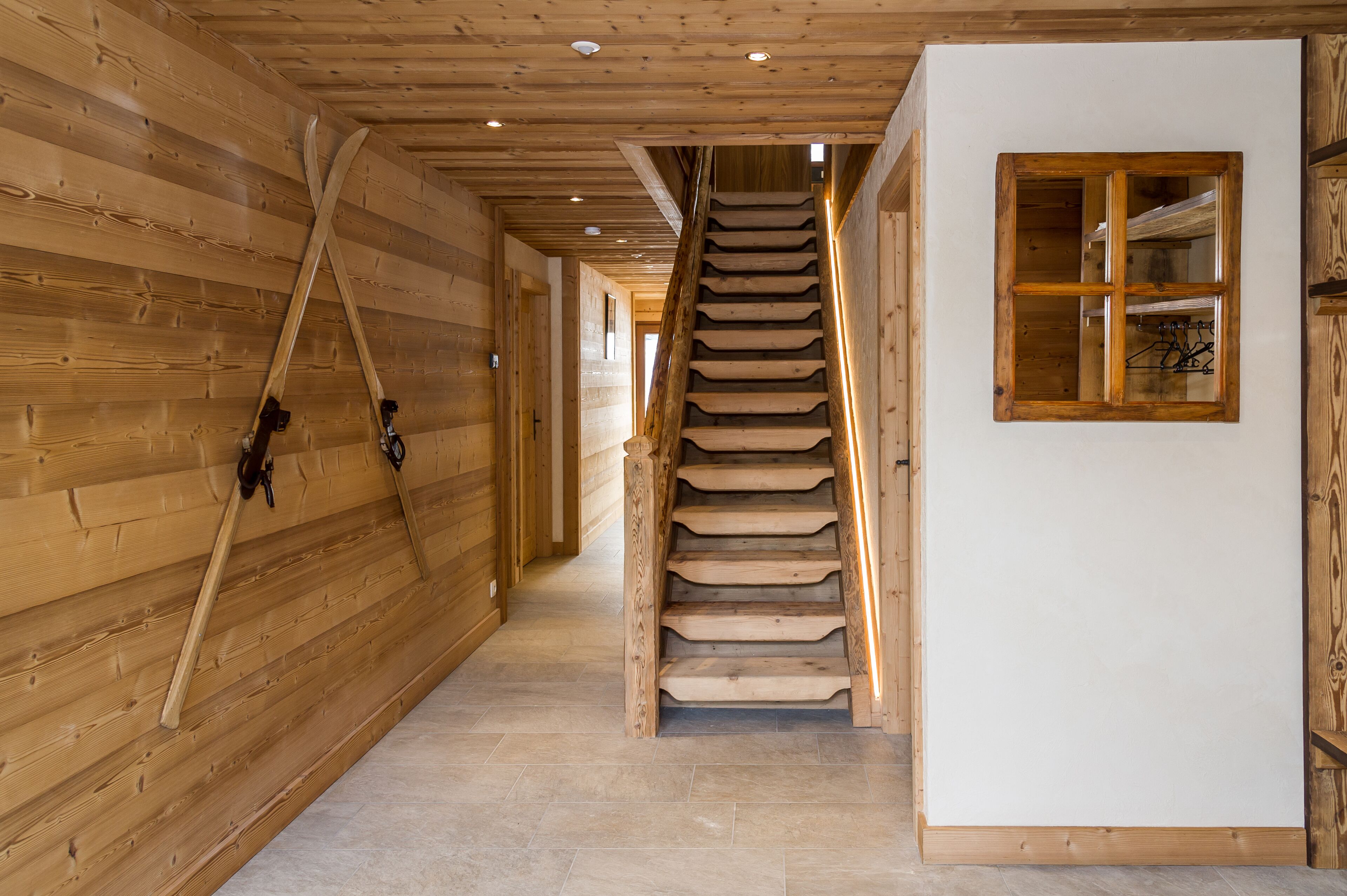 Ein Holzboden-Flur mit einer Treppe zu einem Zimmer.