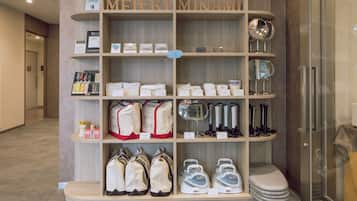 A display of travel accessories including bags, mirrors, and toiletries in a store.
