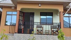 A building with a balcony, a stone facade, and a metal railing. - Sumawe Suites Karatu (Karatu)