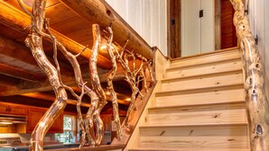 A wooden staircase with a unique branch-like design. - Cozy Family Cabin Getaway-Game Room+Fire Pit, EV outlet-Near Waterfalls, Parkway (Maggie Valley)