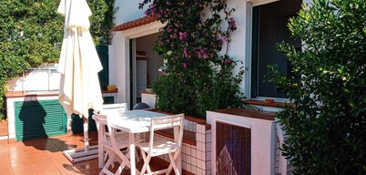 Small house with large terrace overlooking the sea