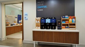 A coffee station with multiple coffee makers and a sign that reads "MUST. HAVE. COFFEE." - Holiday Inn Express Doral Miami by IHG (Miami)
