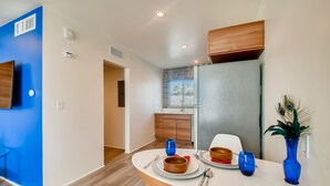 A modern kitchen with a dining area. - Hollywood Studios in Downtown Phoenix (Phoenix)