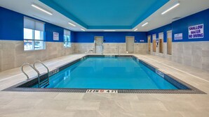 An indoor swimming pool with a blue and white color scheme, shallow water warning signs, and a 122m/4ft depth marker. - Hampton Inn by Hilton Brockville (Brockville)