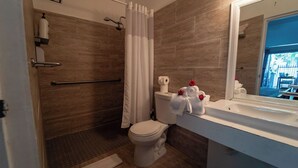 A bathroom with a shower, toilet, and sink. - Casa Sevilla, Coqui Studio (San Juan)
