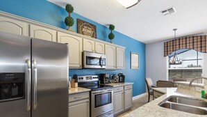 A modern kitchen with stainless steel appliances, a microwave, and a built-in oven. - Welcome to The Windsor Dream! (Kissimmee)