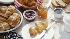 A breakfast setting with bread, pastries, jams, honey, and coffee. - Double room with balcony in the heart of Brussels (Bruxelles)