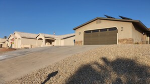 A residential property with a garage, a driveway, and a landscaped area with gravel.