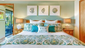 A bedroom with a bed, two bedside tables, a wooden headboard, and three framed wall art pieces. - Spectacular Panoramic Ocean Views - Private Ohana - Wailea Custom Pole Home (Kihei)