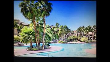 Relax by the resort pool surrounded by lush tropical vegetation and modern architecture.
