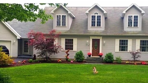 A two-story house with a front porch, a dog in the yard, and a well-maintained lawn. - Crew Road Cabana (Clifton Park)