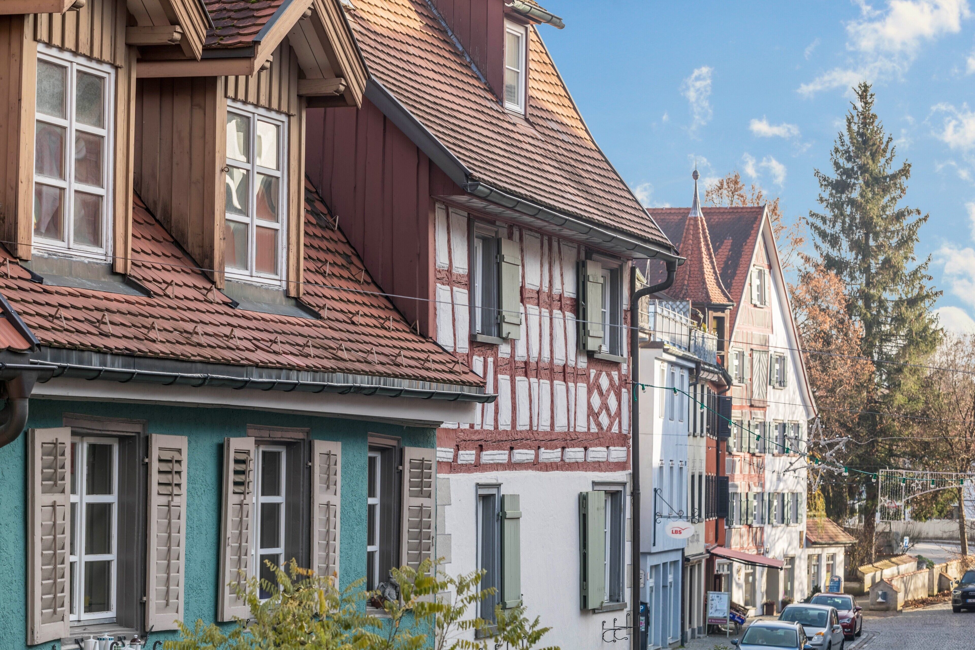 Eine Reihe traditioneller europäischer Gebäude mit Fachwerk, steilen Satteldächern und Fensterläden.