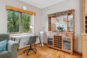 A room with a desk, chair, and a wooden cabinet with glass doors. - Tranquil rural area, near major roads and shops (Lake Elmo)