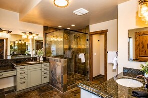 A modern bathroom with a glass-enclosed shower, a vanity with a sink, and a large mirror. - Last-Min Summer Escape! Book Jul/Aug Stay by 7/31, 15% Off (Pagosa Springs)