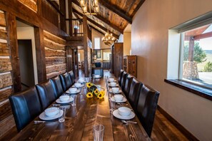 A long wooden dining table set for a meal, with leather chairs on either side. - Last-Min Summer Escape! Book Jul/Aug Stay by 7/31, 15% Off (Pagosa Springs)
