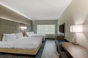 A hotel room with two beds, a desk, a chair, a TV, and a window with a view of trees. - Fairfield by MarriottInn & Suites Nashville Antioch (Antioch)