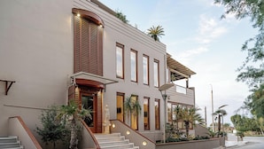 A modern building with a staircase, large windows, and outdoor plants. - Xenios Dias Apartments (Chania)