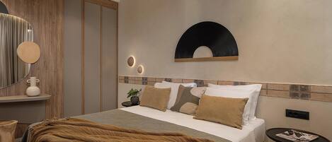 A modern bedroom with a bed, bedside table, and a mirror.