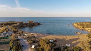 A coastal area with a road, beach, and rocky outcrops. - Xenios Dias Apartments (Chania)