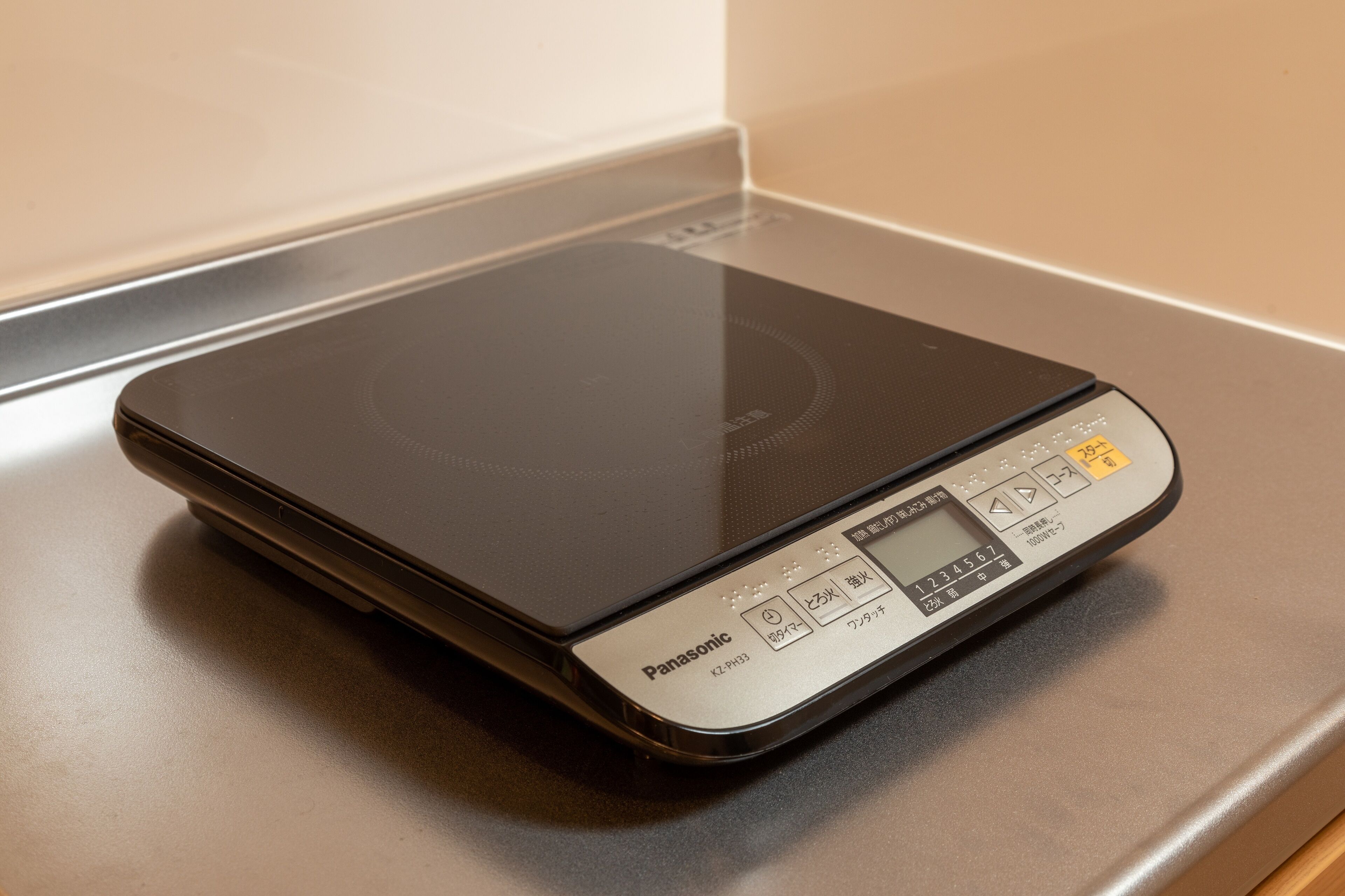 A Panasonic electric kettle with a digital display and buttons on a countertop.