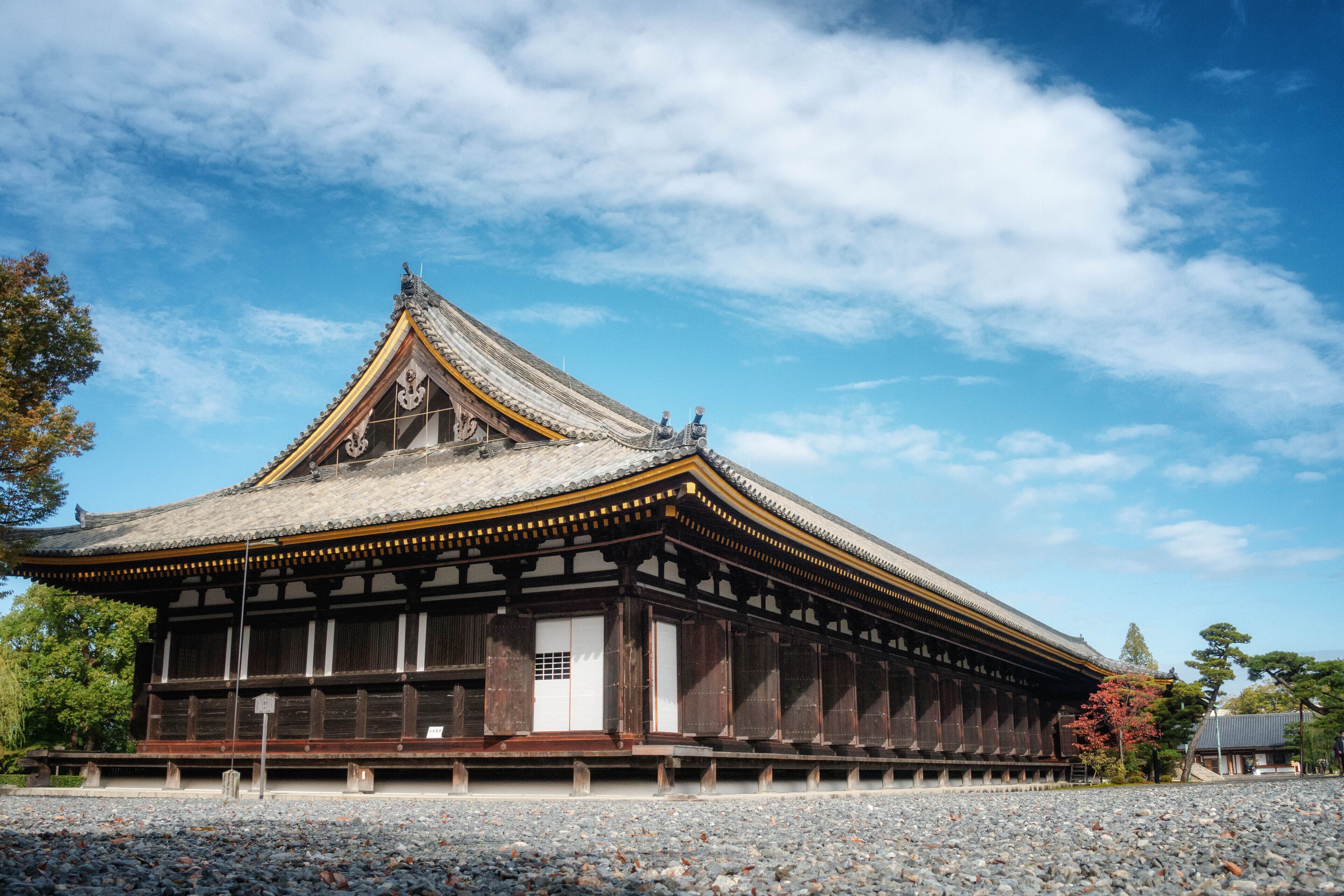 A traditional Japanese building with a tiled roof and wooden structure.