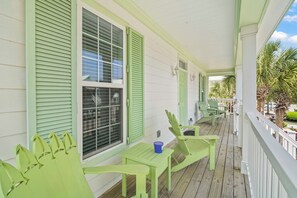 A porch with green shutters, a table, and chairs. - Spacious Surfside Beach Home Minutes from the Ocean. Pet-Friendly! (Murrells Inlet)