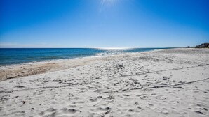 A beach with a clear sky and the sun shining. - Coastal Cottage is situated on the island's east end near the State Park. (St. George Island)