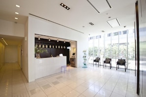 Welcome to the reception area, where guests can check in and relax in a comfortable seating space.