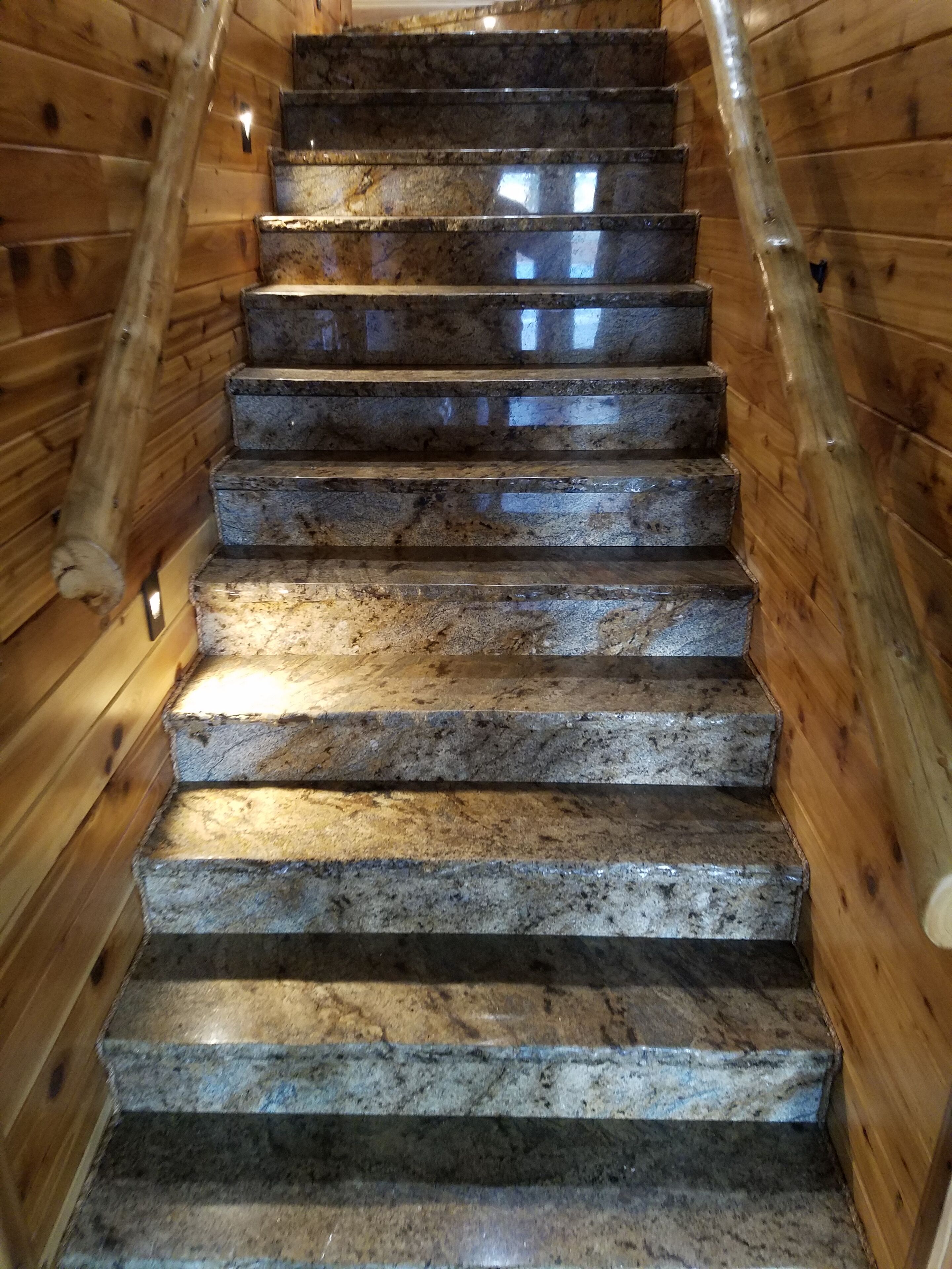 A wooden staircase with stone steps leading upwards.
