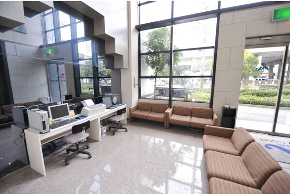 Guests can wait comfortably in this spacious area with a long reception desk and ample seating options.