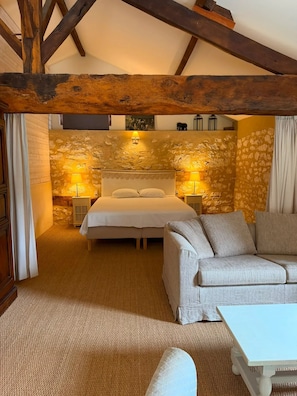 A bedroom with a bed, a sofa, a nightstand, and a lamp. - Homerez - "Sigoulès villa with pool" (Sigoulès)