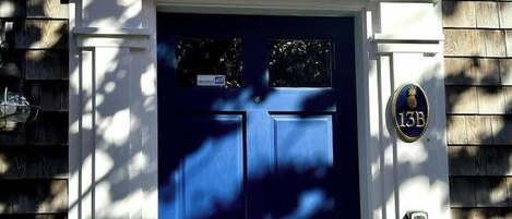 A blue door with a sign above it that reads 'You've Got Whale.'