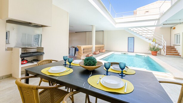 An outdoor dining area with a pool, a grill, and a staircase leading to an upper level. - Casa moderna con piscina privada y barbacoa, YourHouse Villa Marian (Muro)