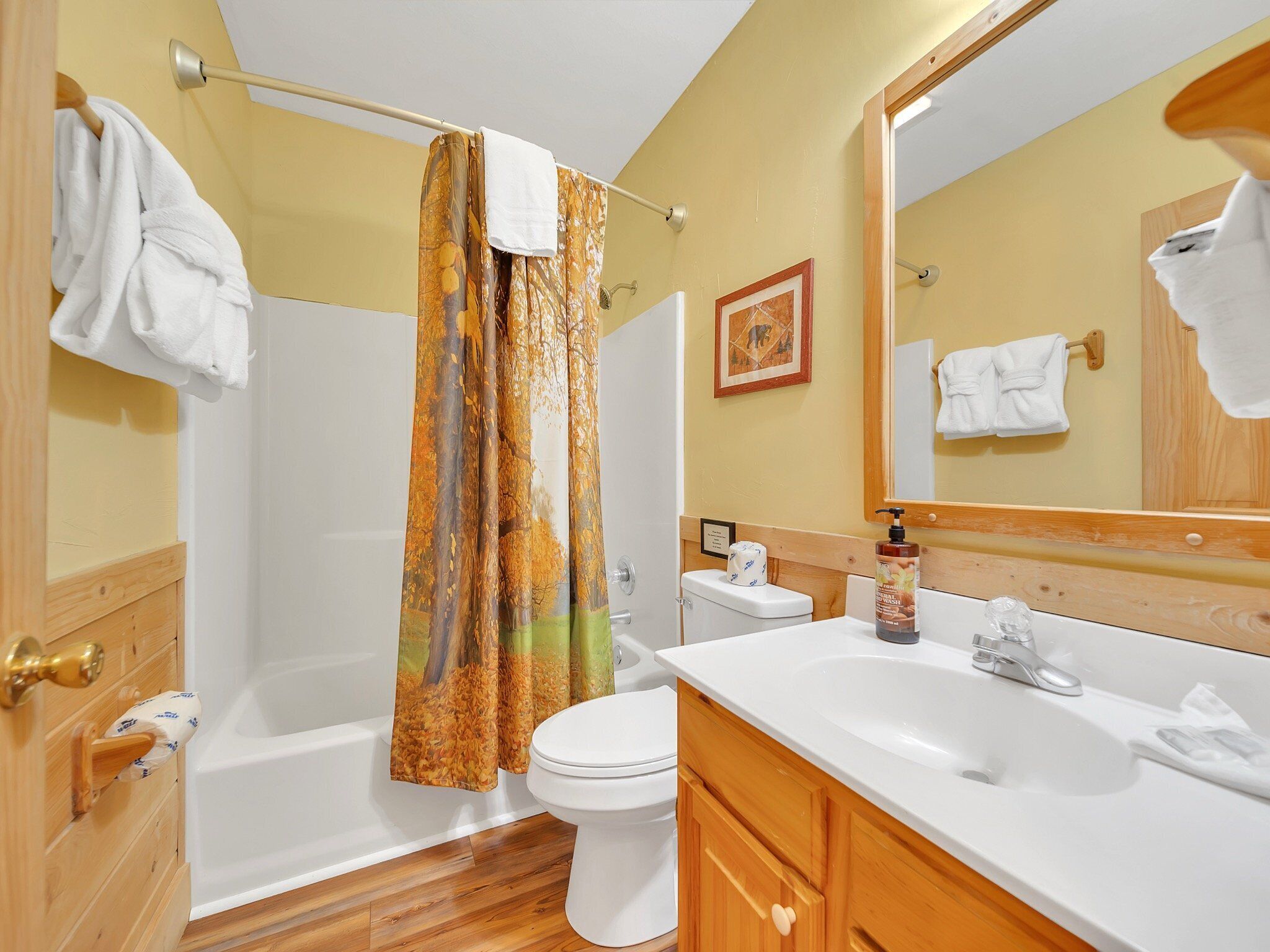 A bathroom with a bathtub, toilet, and sink.