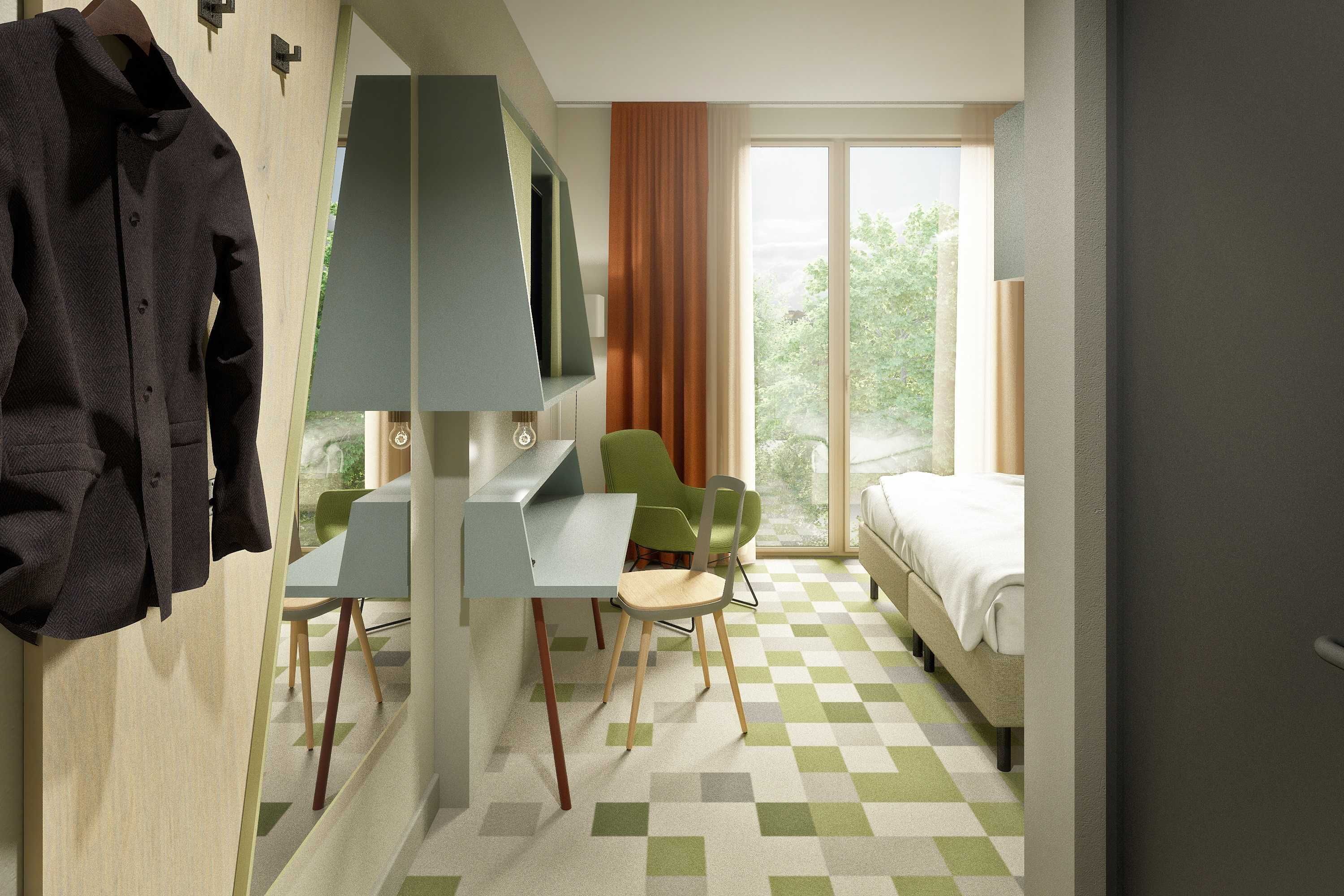 A hotel room with a desk, two chairs, a bed, and a large window with a view of greenery.