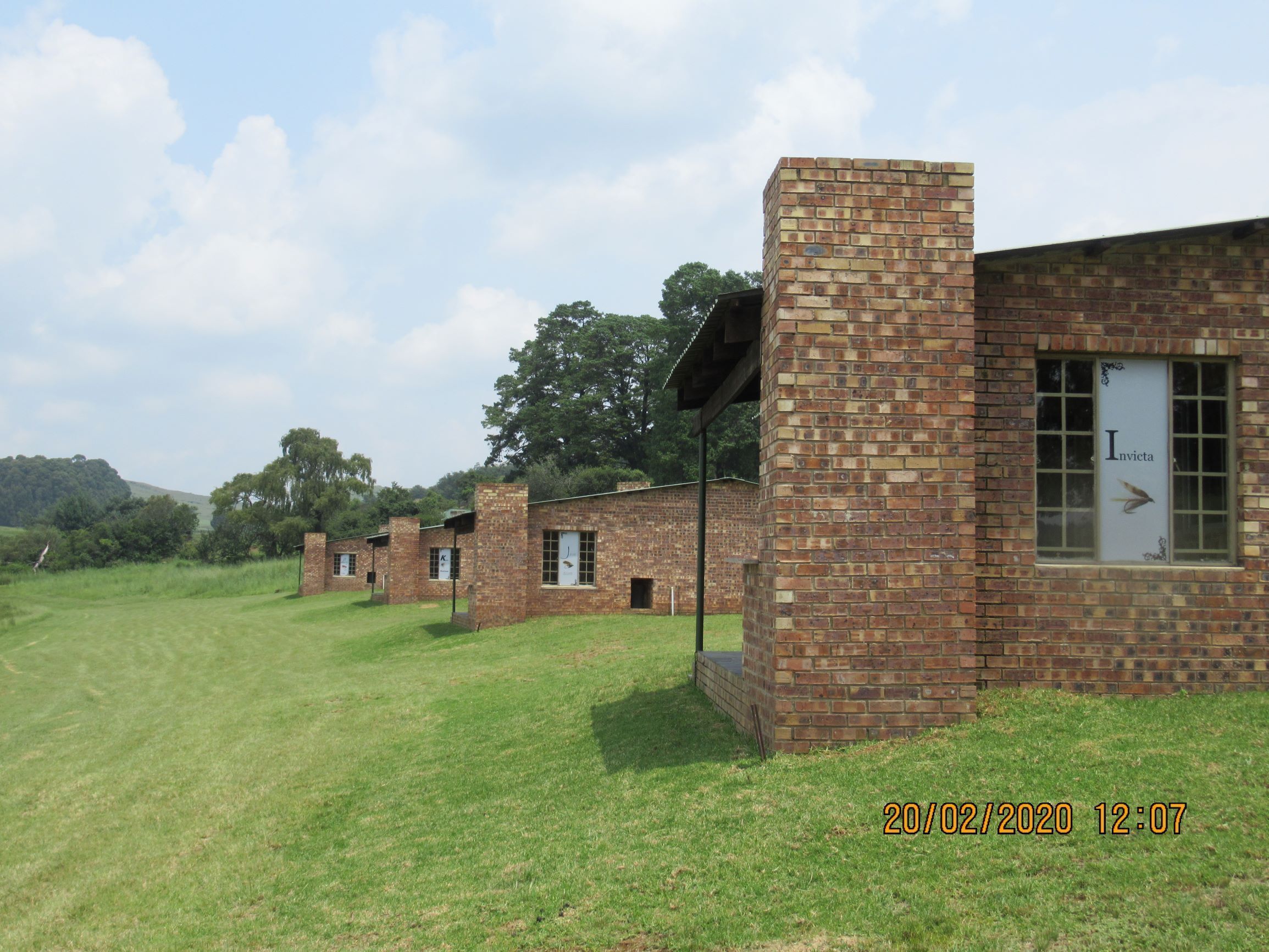 A row of brick buildings with a sign reading "Invicta" on one of them.