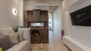 A modern living room with a sofa, a coffee table, and a wooden cabinet with decorative items.